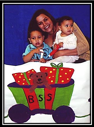 A family posing with the BSS Christmas train